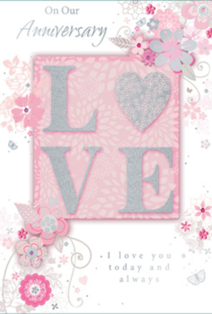 The anniversary card in this image feels like a paper bouquet arranged with the same sensitivity a Crofton Park florist brings to a hand-tied arrangement for a quiet celebration at home. At its heart, the word LOVE appears in bold, raised lettering, finished in a crystalline glitter that sparkles delicately rather than glaring, reminiscent of soft sunlight glancing off the windows of Victorian houses along Brockley Road. The letters sit on a slightly deeper blush-pink rectangular panel, which provides a warm, romantic anchor in the middle of the card. Beyond this, the background shifts to a paler pink that almost melts into creamy white at the edges, giving a sense of depth and gentle light. Flowing outwards from the central motif, airy, stylised flowers and trailing leaves curve around the corners and sides. These blooms are drawn in fine, almost calligraphic lines of light grey and white, with small, carefully placed accents of silver that glimmer like tiny pieces of foil pressed into the card. The flowers themselves feel like a florist's daydream: soft, rounded petals, delicate sprays, and curling vines that suggest movement, as though a breeze had passed across the card. Interspersed among the florals are subtle flourishes - swirling tendrils, tiny clusters of dots, and branching stems - creating a sense of quiet abundance. Above and below the central panel, an elegant script in a muted grey ink carries a loving anniversary message, its lettering smooth and well-spaced, easy on the eye. The whole composition suggests enduring affection and calm joy, perfect to slip alongside pastel stems delivered for an anniversary dinner in a Crofton Park flat overlooking the park itself.