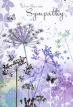 This sympathy card presents a tranquil vision that feels entirely at home in the quieter corners of Crofton Park, where life seems to slow for a moment of reflection. Across the inner panel, fine, upright stems of wild umbel flowers rise from a soft, misty base of watercolour tones-lavender, dusky violet, and faded sage. Each flower head is a tiny constellation of filigree lines, the kind of delicate structure you might notice on a thoughtful walk along Brockley Road or through the leafy side streets, when your mind is full and the world around you feels hushed. The background fades gently from pale purples into gentle blue-greys, like distant clouds parting after a passing shower, leaving a tender glow behind. Scattered lightly among the flower heads are several butterflies, painted as though made from gossamer, their wings tinted with faint blues and mauves. They hover just above the blossoms, neither flying fast nor fully at rest, embodying both fragility and quiet strength, a visual nod to the way love persists through change and loss. The entire design is carefully balanced: enough detail to convey the intricacy of nature, yet softened by fluid washes of colour and open space where the heart can breathe. For someone choosing a condolence card to send with locally delivered flowers, this image offers a gentle, composed form of support-an unspoken message that in the stillness after sorrow, there remain moments of beauty, remembrance, and calm, held tenderly within the petals, stems, and softly drifting wings.